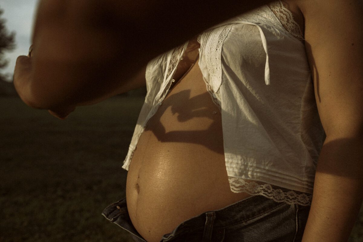Outdoor maternity photography in Richmond VA with vintage tones and golden hour lighting
