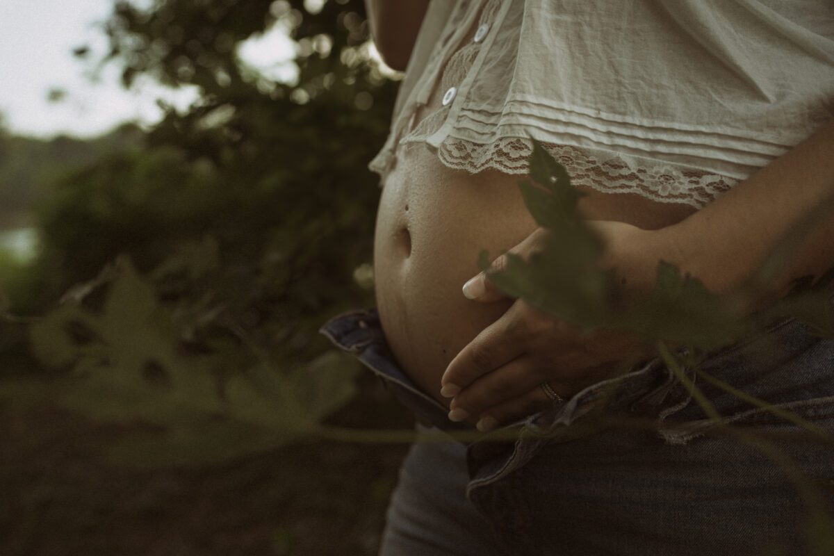 Outdoor maternity photography in Richmond VA with vintage tones and golden hour lighting